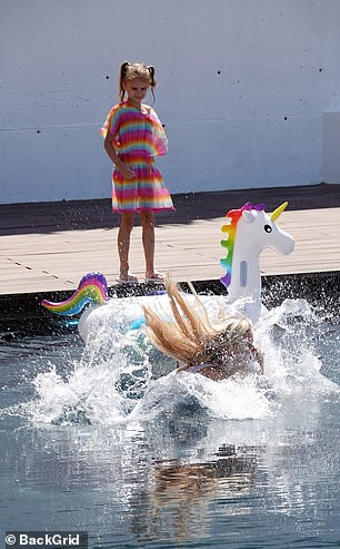 Company: She jumped into the water next to an inflatable unicorn