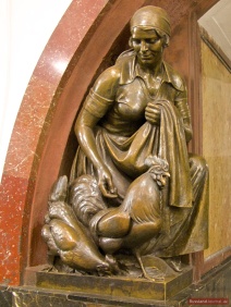 Girl with hen and cock, a statue of Ploshchad Revolyutsii Metro Station in Moscow